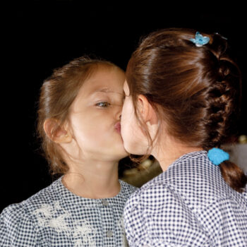 school girl kissing a mirror