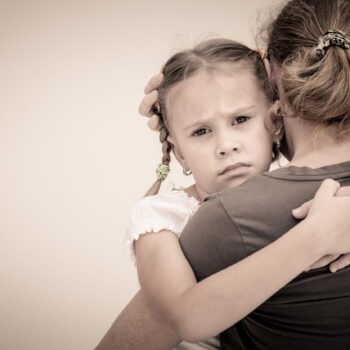 sad daughter hugging mother
