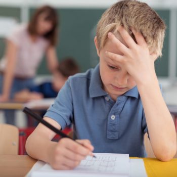 child i classroom doing school work and struggling