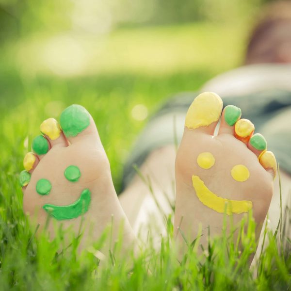 Bottom of feet painted with smiley faces